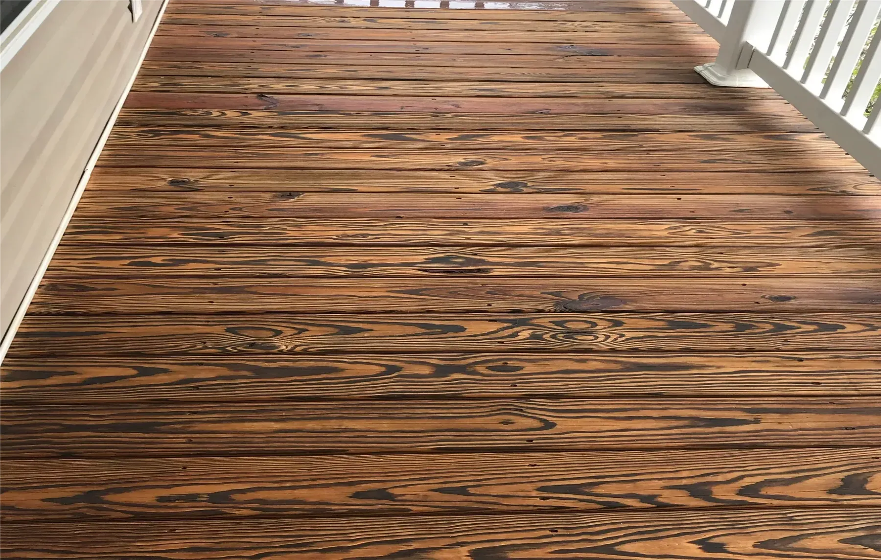 Close view of deck boards with a fresh amber stain