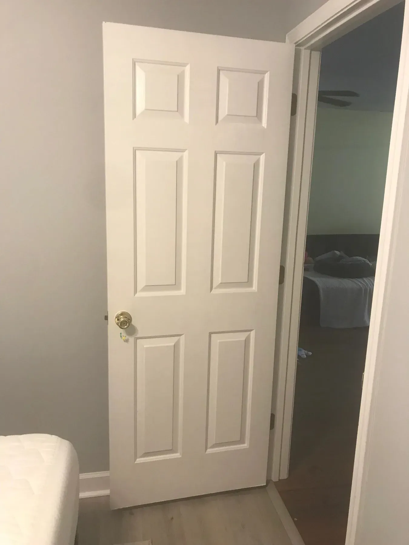 A six-panel interior door refinished in clean white
