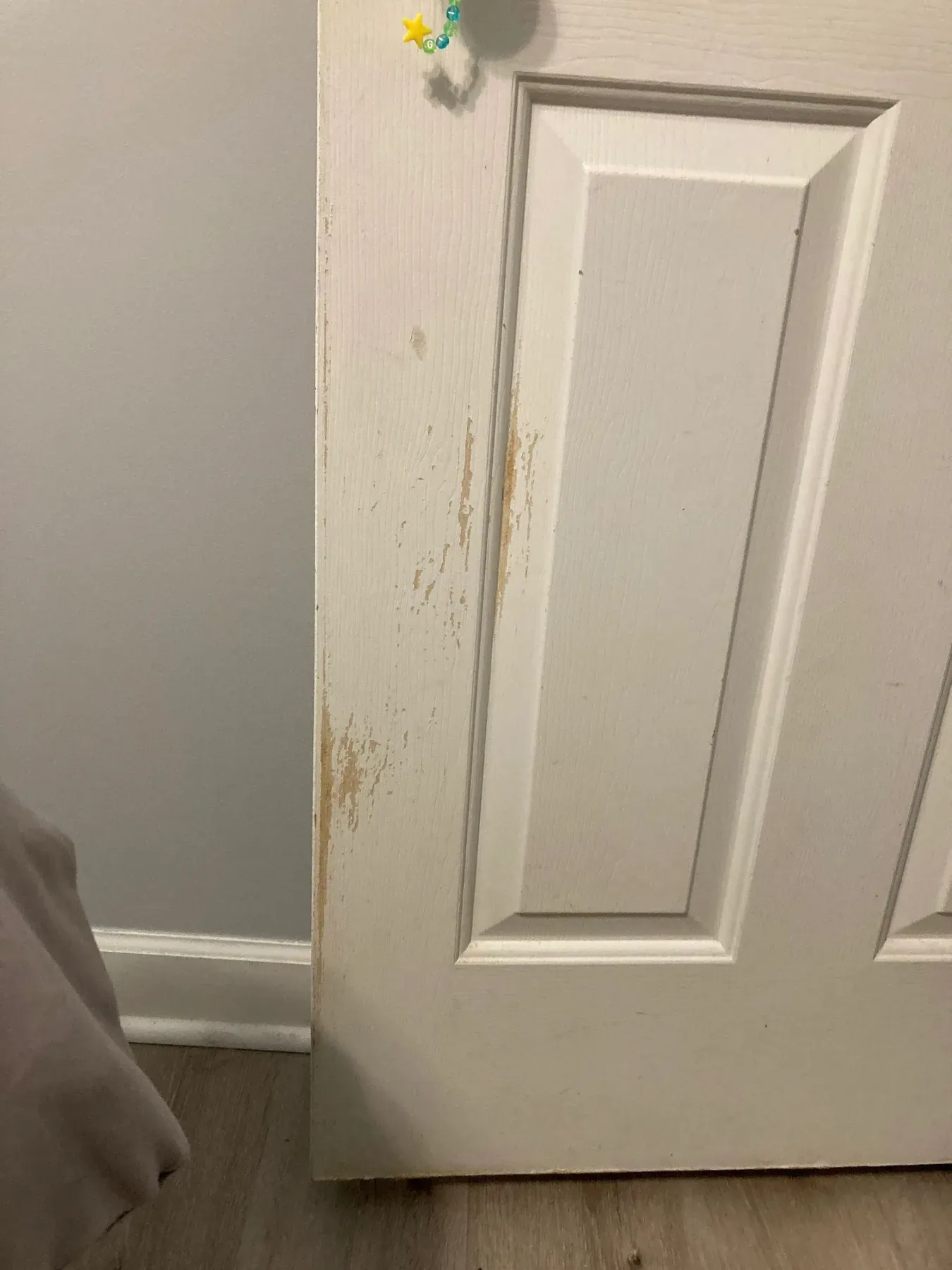 A chipped and stained six-panel door